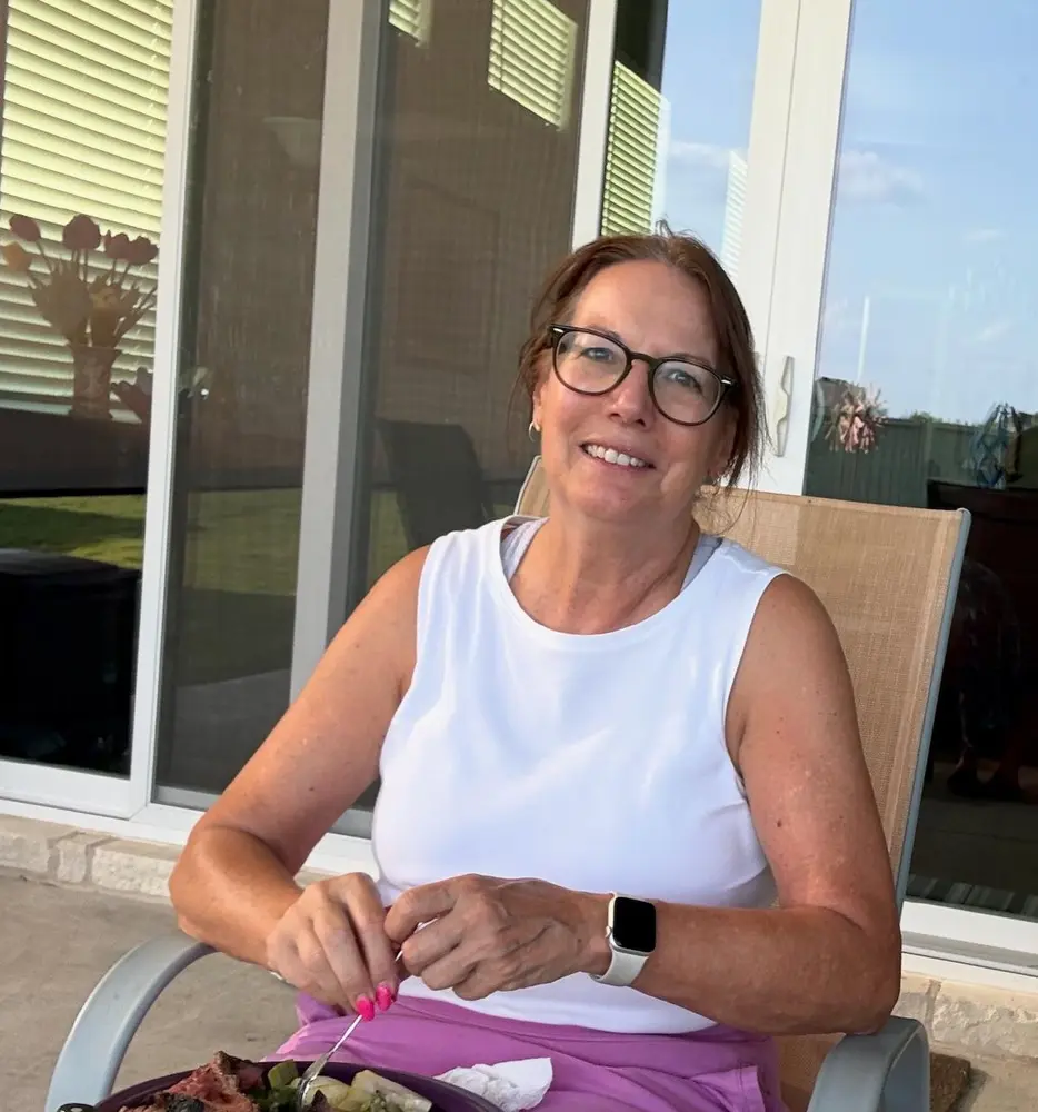 Carol seated outdoors