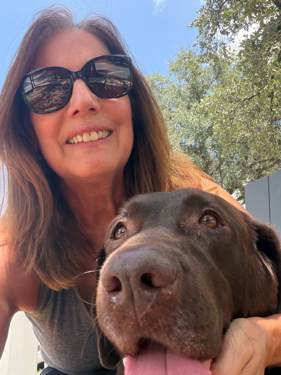Carol smiling with Nala outdoors