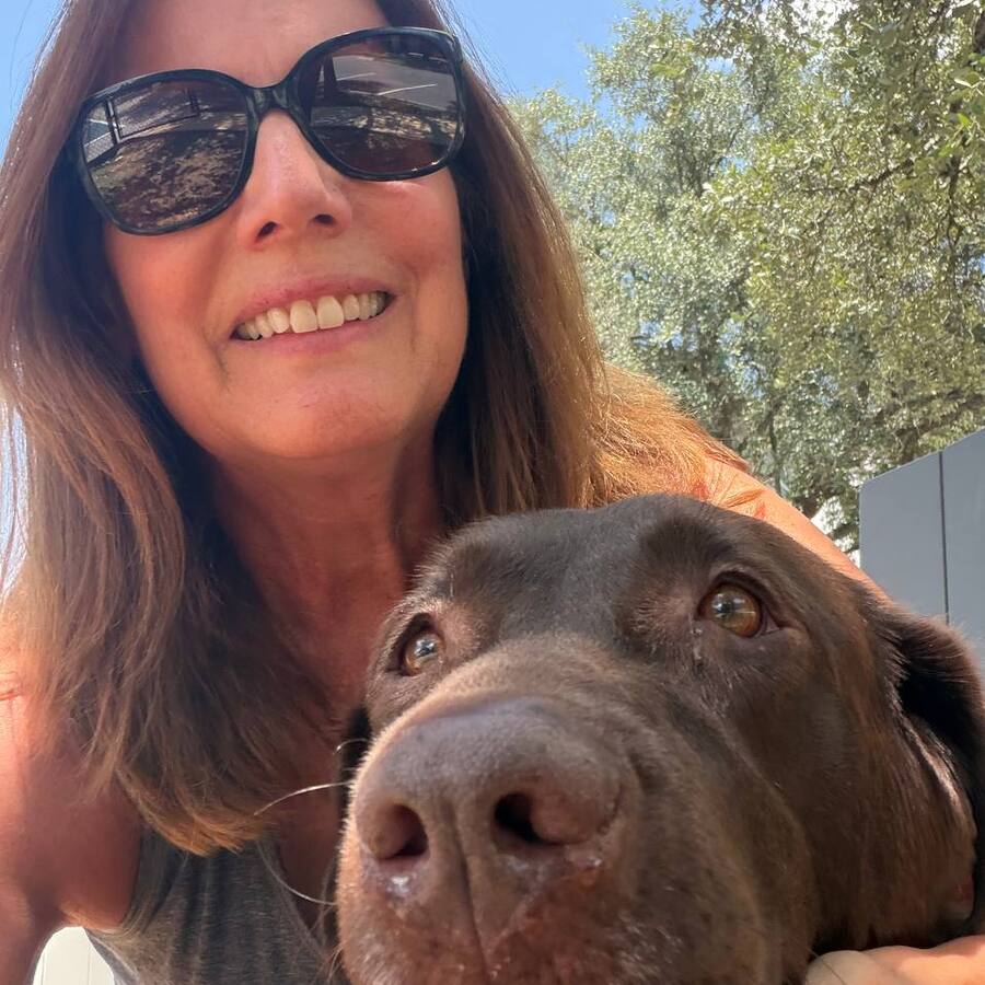 Carol smiling with Nala outdoors